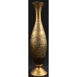 A Persian brass slender baluster vase, chased in the archaic Islamic taste with traditional