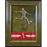 Football - an early 20th century silvered metal plaque, as a footballer on the dribble, framed
