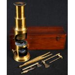 A 19th century botanist's lacquered brass monocular microscope and equipage, including a pair of