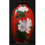 A Japanese cloisonné enamel panelled ovoid vase, decorated with cherry blossom and a butterfly in
