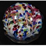 A late Victorian glass paperweight, the domed top enclosing a colourful Nailsea pad, centred by