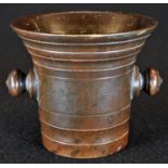 An 18th century bronze bell-shaped apothecary mortar, turned lug handles, numbered 3 to base, 10cm