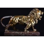 Continental School (19th century), a gilt bronze, of a lion, standing, fierce, rectangular marble