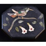 A pietra dura lozenge shaped desk weight, inlaid in specimen stones with a bird on a blossoming