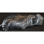 A North American Inuit carving, of a reclining seal, naturalistically carved, 13.5cm long, inscribed