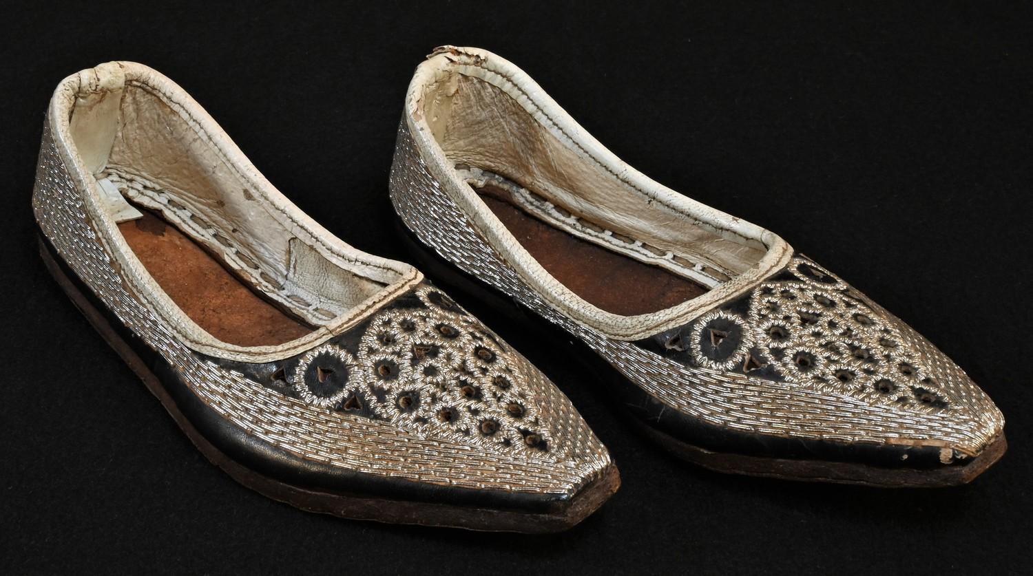 A pair of Ottoman child's shoes, profusely worked in silvered thread, 16cm long