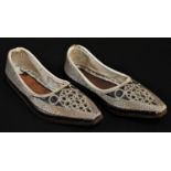 A pair of Ottoman child's shoes, profusely worked in silvered thread, 16cm long