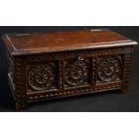 An early 20th century oak box, as a 17th century blanket chest, hinged cover, the panelled front and