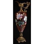 A large Rococo Revival gilt-metal mounted ewer, the ovoid ceramic reservoir painted in colourful