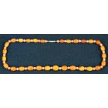 An amber bead and coral necklace, gold coloured metal clasp, 22cm drop, 16.9g gross