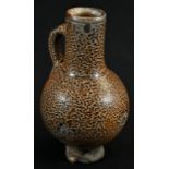 A 16th/17th century tiger glaze stoneware bellarmine, loop handle, 22cm high, c.1580 - 1650