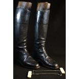 A pair of early 20th century leather riding boots, the three-section brass-mounted trees by