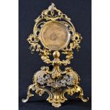 A 19th century French Rococo Revival gilt metal pocket watch stand, pierced and cast throughout with