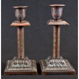 A pair of Victorian Grecian Revival coppered candlesticks, fluted Campana sconces, square drip