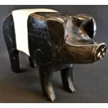 A softwood shop display model, of a pig, as an oversize money box, coin aperture to back, the tail