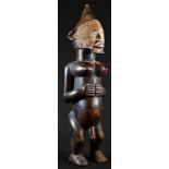 Tribal Art - a Dan figure, standing, with hermaphroditic physiology, stylised scarified features