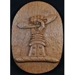 Heraldry - an Arts and Crafts oak armorial, carved in relief with the crest of Shuttleworth, of