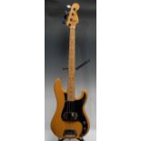 A Fender Precision electric bass guitar USA, natural wood body, maple neck, black pickguard.