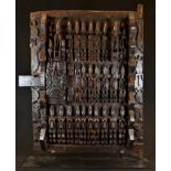 Tribal Art - a Dogon grain store door, carved with a geometric arrangement of stylised figures, 59cm