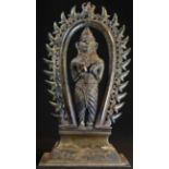 A 19th century Indian shrine figure, cast as a deity, standing, beneath a nimbus, rectangular