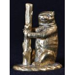 Bear Baiting - an early 20th century gilt brass so-to-bed, as a bear and staff, his hinged head