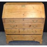 A 19th century pine bureau, slope top fitted interior, over four graduated drawers