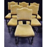A set of six Victorian ebonised dining chairs shaped stuffed over backs and seats, in gold