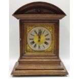 A late 19th century oak mantel clock, Roman numerals, twin winding holes, eight day movement,