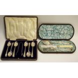 A Victorian aesthetic movement 3 piece christening set; sugar tongs and teaspoons set, both cased (