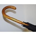 An Edwardian black umbrella, hook handle, yellow metal collar stamped 18ct, WH, dated 1923