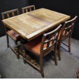 An oak draw leaf table and four dining chairs