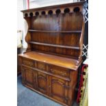 An oak dresser by Renaissance Furniture, plate rack with arched cornice, above 3 drawers and 3