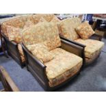 An Ercol three piece suite comprising three seat sofa with wickerwork sides and two conforming
