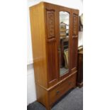 An Art Nouveau wardrobe, central mirror door flanked by carved panels, deep drawer to base (AF)