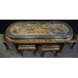 An oriental oval carved coffee table nest, decorated with traditional landscape, samurai warriors in