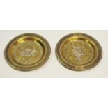Two silver inlaid brass dishes, 13.5cm diameter