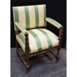 An oak upholstered open arm elbow chair, overstuffed seat and arms, carved and turned and supports