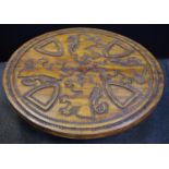 An unusual Spanish carved fruit wood coffee table, circular top carved and chased with Lions Rampant