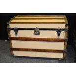 A dome top wood and metal bound trunk, 62cm high x 92cm wide x 57cm deep