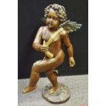 A large bronzed metal figure, Cherub, standing leg raised, gripping a horn in his right hand,