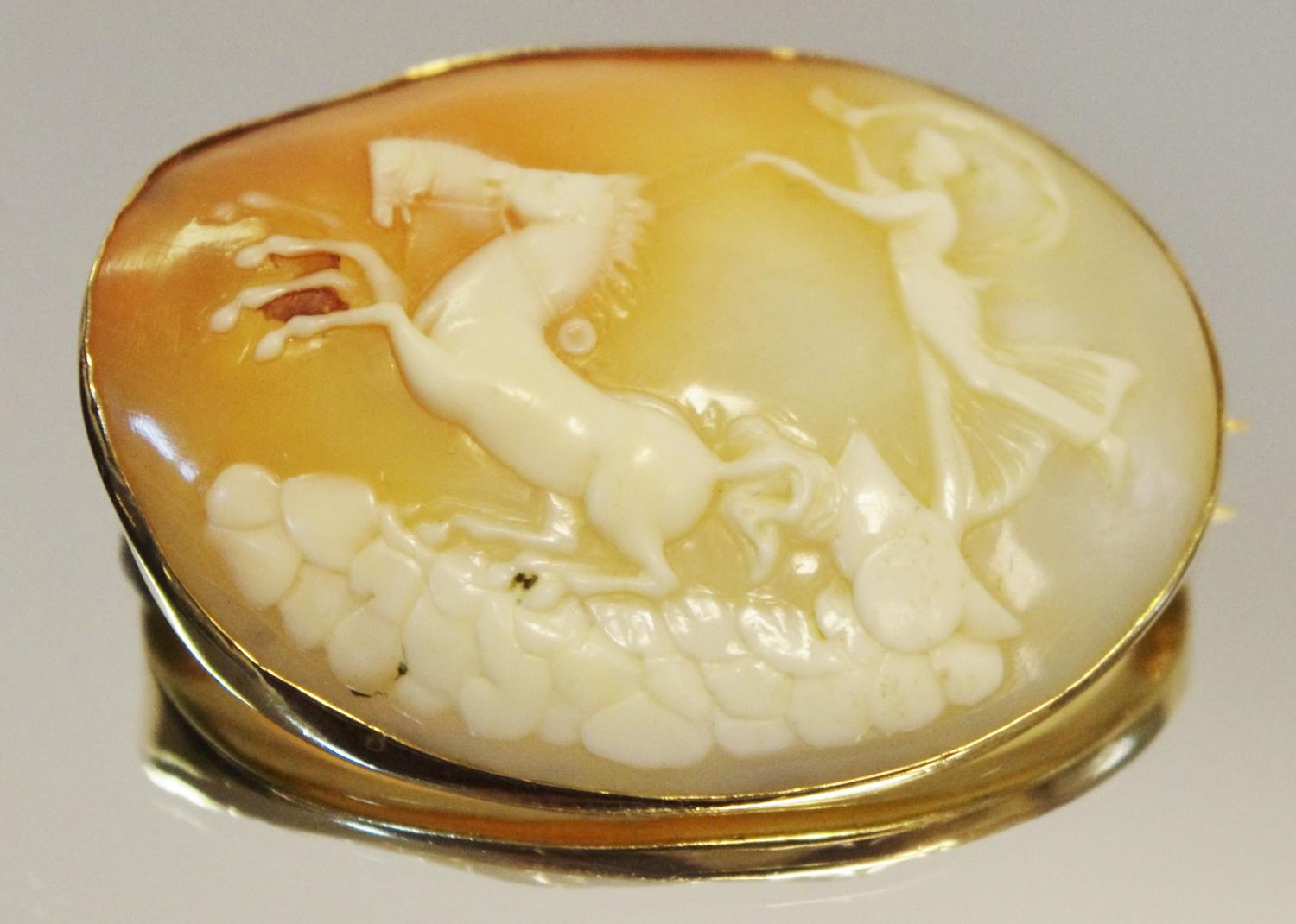 A yellow metal mounted cameo depicting Goddess of the Dawn