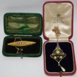 A 15ct gold marquis shaped bar brooch set with five rubies and six diamonds, original fitted case