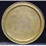 A large Sino-Tibetan brass tray table top wall plaque, central engraved roundel of Peacock wings