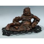 A Chinese hardwood figure, carved as Liu Hai and a three legged toad, carved and pierced base,