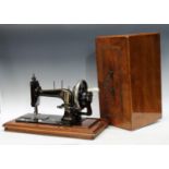 An early 20th century hand sewing machine, mahogany case.
