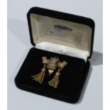 An ornate Victorian tassel brooch, boxed