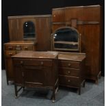 An oak three piece bedroom suite, mirrored door wardrobe with base drawer, side cabinet, dressing