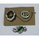 Two Sterling silver enamel maple leaf brooches; An MSSULHL silver and enamel golfing brooch,