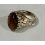 Jewellery - a gentleman's silver signet ring with tiger's eye polished stone cabochon, London 1969