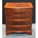 A George III style crossbanded mahogany bow fronted bachelor?s chest, brushing slide above four